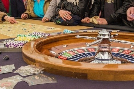 Roulette being played with players on a table.